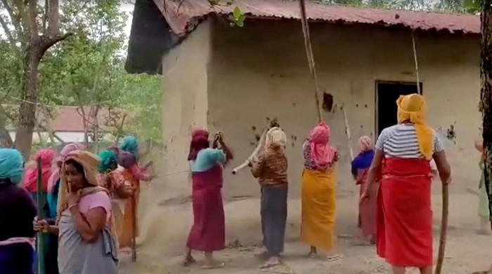 Women hit on walls of house of the accused in viral Manipur video case, in Pechi Awang Leikai, Manipur, India, July 20, 2023, in this screengrab obtained from a Handout video. ANI/via REUTERS
INDIA OUT. NO COMMERCIAL OR EDITORIAL SALES IN INDIA. THIS IMAGE HAS BEEN SUPPLIED BY A THIRD PARTY.