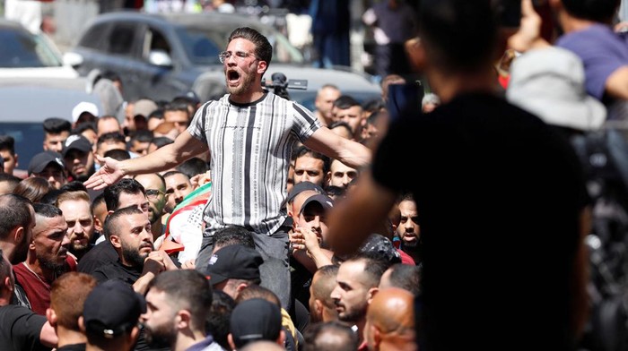 A man reacts as mourners carry the body of a Palestinian who was killed during clashes with the Israeli army in Nablus, in the Israeli-occupied West Bank, July 20,2023. REUTERS/Mohamad Torokman