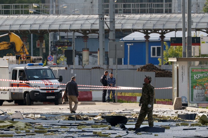 Members of the security services investigate the site of a damaged building following a reported drone attack in Moscow, Russia, July 24, 2023. REUTERS/Maxim Shemetov