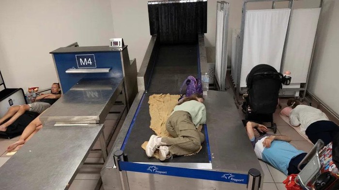 Tired tourists have been photographed inside the airport at Rhodes. Source: Reuters