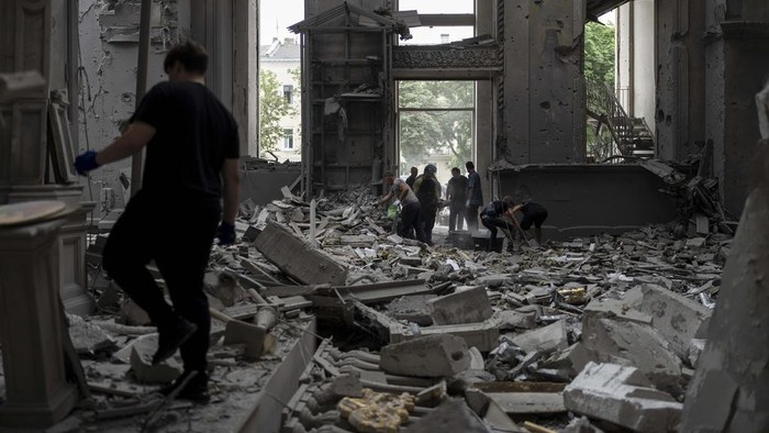 Church personnel inspect damages inside the Odesa Transfiguration Cathedral in Odesa, Ukraine, Sunday, July 23, 2023, following Russian missile attacks. (AP Photo/Jae C. Hong)