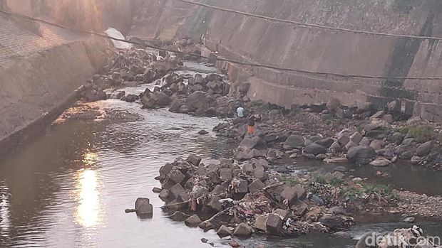 Tinggi muka air (TMA) Sungai Ciliwung di Bendung Katulampa Bogor menyentuh titik 0 cm. Kondisi ini disebut terjadi selama Juli. Sejumlah warga asyik memancing (M Sholihin/detikcom)