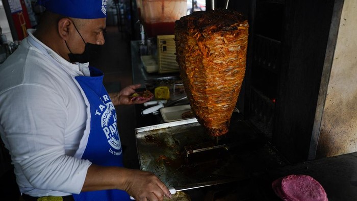 A cook prepares a taco with a Barbie themed pink tortilla at a restaurant in Mexico City, Thursday, July 20, 2023. The restaurant is offering tacos to its customers, made with these Barbie-themed tortillas where the corn dough is colored pink with beet juice. (AP Photo/Eduardo Verdugo)