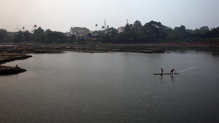 Sungai Cisadane Menyurut Gegara Kemarau dan Pintu Air Jebol Warga berjalan di kawasan sungai Cisadane yang airnya mulai surut di kawasan Pintu Air 10, Tangerang, Banten, Selasa (25/7/2023). Surutnya air sungai Cisadane sudah terjadi sejak satu bulan terakhir karena tidak adanya hujan di wilayah Tangerang dan berkurangnya debit air kiriman dari Bogor. ANTARA FOTO/Muhammad Iqbal/nym.