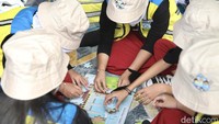 Sejumlah anak menyusun puzzle yang bertemakan Hari Sungai Nasional di Tepi Sungai Ciliwung Jembatan Transmart MT Haruono, Jakarta, Kamis (27/7/2023). 