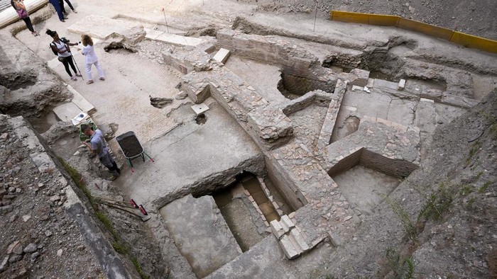 People walk in the excavation site of the ancient Roman emperor Neros theater, 1st century AD, during a press preview, in Rome, Wednesday, July 26, 2023. The ruins of Neros Theater, an imperial theater referred to ancient Roman texts but never found, have been discovered under the garden of the future Four Seasons Hotel, steps from the Vatican, after excavating the walled garden of the Palazzo della Rovere since 2020, as part of planned renovations on the Renaissance building. (AP Photo/Andrew Medichini)