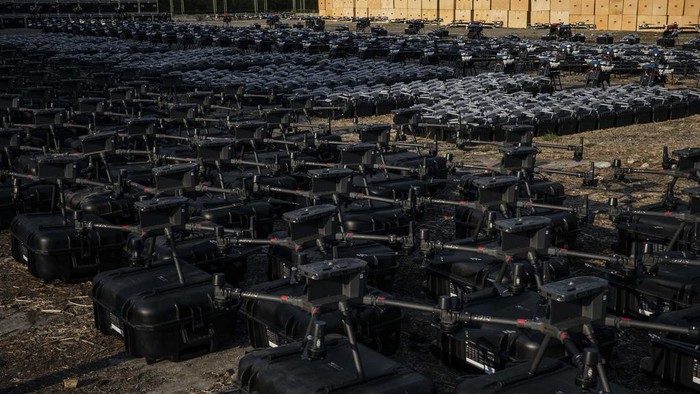 Mykhailo Fedorov, Ukrainian minister of digital transformation, right, and Yuriy Shchygol, head of State Special Communications Service, pose for a photo next to 1700 drones that are being sent to the frontline to be used against Russian forces, in Kyiv, Ukraine, Tuesday, July 25, 2023. (AP Photo/Libkos)