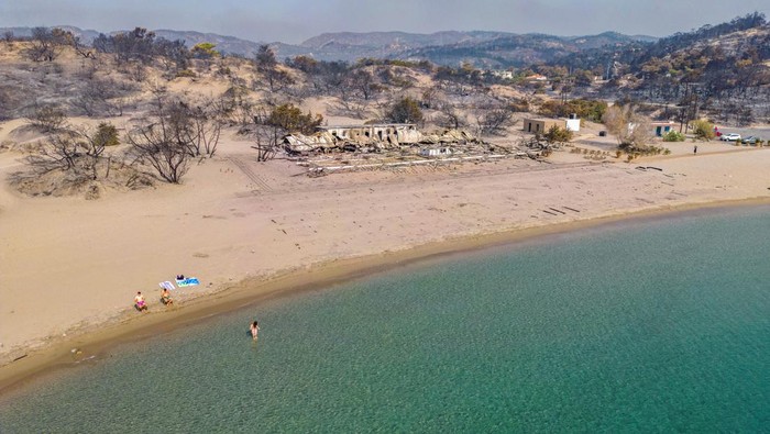 An aerial view of burned land by the sea, as a wildfire burns on the island of Rhodes, Greece, July 27, 2023. REUTERS/Nicolas Economou