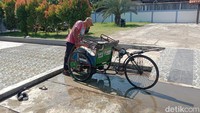 Warga mengambil air sumur keramat bukan hanya untuk mandi atau minum. Ada juga yang digunakan warga untuk sekedar membilas kendaraan roda tiganya. (Foto: Sudedi Rasmadi/detikJabar)