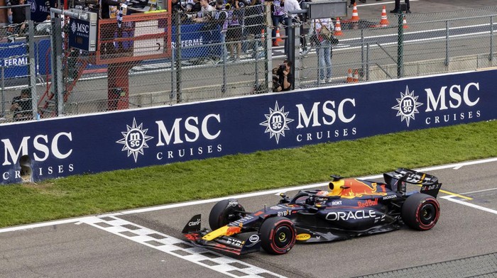 Red Bull driver Max Verstappen of the Netherlands receives the checkered flag as he crosses the finish line to win the Formula One Grand Prix at the Spa-Francorchamps racetrack in Spa, Belgium, Sunday, July 30, 2023. (AP Photo/Geert Vanden Wijngaert)