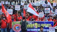 Peserta aksi mengangkat poster berisi tuntutan saat berdemonstrasi kawasan Patung Kuda Arjuna Wiwaha, Jakarta, Senin (31/7/2023).