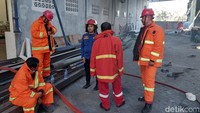 Potret petugas Damkar yang berjibaku memadamkan api. Pemadaman juga dibantu dari Unit Damkar dari Lakarsantri, Surabaya. Foto: Jemmi Purwodianto/detikJatim