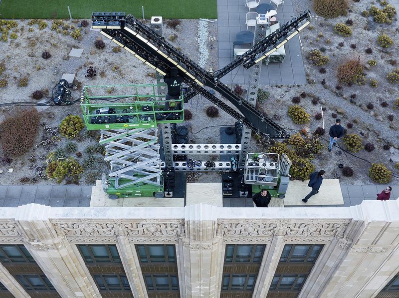 Workers install lighting on an 