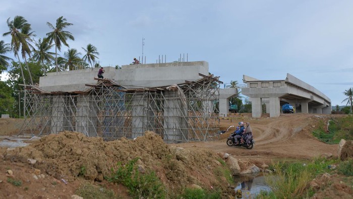 Kendaraan melintas di lokasi pembangunan jalan dan  jembatan menuju pintu Tol Kuta Baro pada Seksi 6 Tol Sigli-Banda Aceh di Aceh Besar, Aceh, Senin (31/7/2023). Kementerian PUPR mencatat enam ruas Jalan Tol Trans Sumatera sepanjang 596 kilometer telah beroperasi penuh hingga Juli 2023 dan tujuh ruas lainnya sepanjang 361 kilometer dalam tahap kontruksi. ANTARA FOTO/Ampelsa/tom.