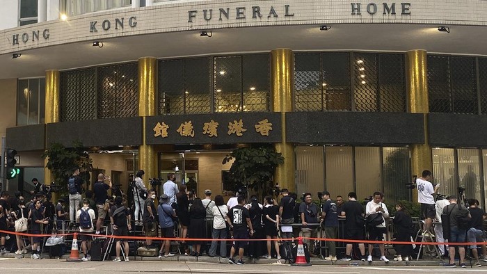 Visitors and members of the media gather outside the Hong Kong Funeral Home, set up for a funeral for Hong Kong singer and songwriter Coco Lee, in Hong Kong on Monday, July 31, 2023. Fans of singer and songwriter Coco Lee, who was known for her powerful voice and live performances, were gathering with flowers to pay their respects at her funeral in Hong Kong. (AP Photo/Annie Cheung)