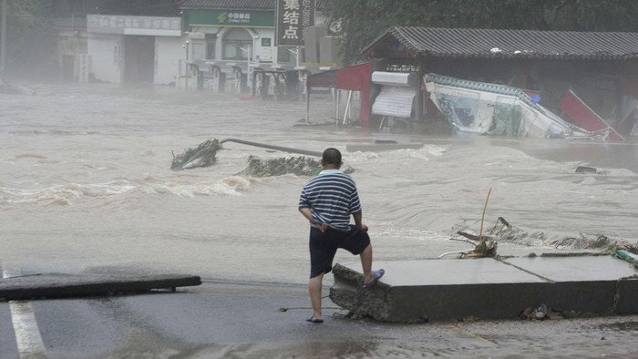 A traditional gate is seen inundated by flood waters in the Miaofengshan area on the outskirts of Beijing, Tuesday, Aug. 1, 2023. Chinese state media report some have died and others are missing amid flooding in the mountains surrounding the capital Beijing. (AP Photo/Ng Han Guan)