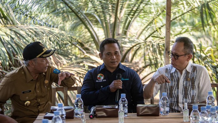 Dukungan pembiayaan petani kelapa sawit oleh OJK Ketua Dewan Komisioner Otoritas Jasa Keuangan (OJK) Mahendra Siregar (kanan) dan Bupati Kabupaten Ogan Komering Iliri (OKI) Iskandar (kiri) berbincang dengan petani kelapa sawit usai penyerahkan bantuan pembiayaan perbankan kepada petani kelapa sawit di Desa Bumi Harapan, Teluk Gelam, Kabupaten Ogan Komering Ilir (OKI), Sumatera Selatan, Senin (31/7/2023). OJK terus berupaya meningkatkan kesejahteraan petani sawit melalui perluasan pembiayaan perbankan dengan skema pendanaan yang inovatif dan terjangkau yang diharapkan dapat meningkatkan produksi kelapa sawit nasional. ANTARA FOTO/Nova Wahyudi/tom.