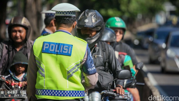 Polisi menilang penerobos jalur TransJakarta di Arteri Pondok Indah, Jakarta. Penilangan dilakukan untuk menertibkan pengendara bandel.
