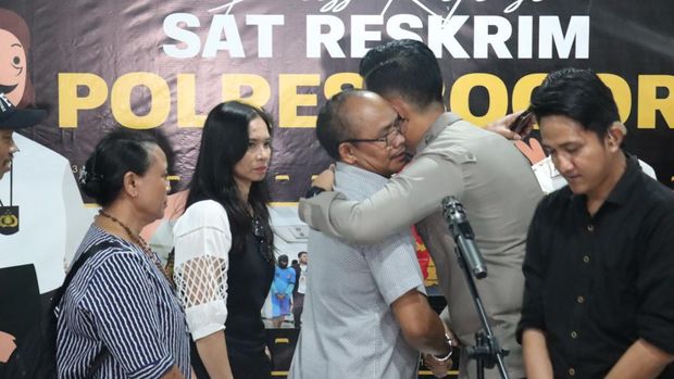 Kapolres Bogor AKBP Rio Wahyu Anggoro mencium tangan ibunda Bripda IDF alias Bripda ID, polisi yang meninggal usai tertembak rekannya Bripda IM. (dok Ist)