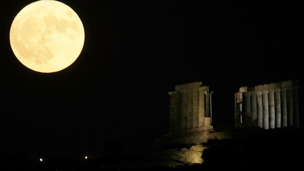 The supermoon rises behind the ancient temple of Poseidon at Cape Sounion, about 70 kilometers (45 miles) south of Athens, Greece, Tuesday, Aug. 1, 2023. The cosmos is offering up a double feature in August: a pair of supermoons culminating in a rare blue moon. Catch the first show Tuesday evening as the full moon rises in the southeast, appearing slightly brighter and bigger than normal. That's because it will be closer than usual, just 222,159 miles (357,530 kilometers) away, thus the supermoon label. (AP Photo/Thanassis Stavrakis)
