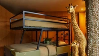 Kamar putra Jhon Legeng bermotif safari adan boneka jerapa yang terpasang. (Dok. Architectural Digest/Yoshihiro Makino)
