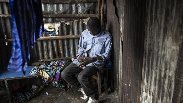 A man sleeps inside a drug den at the Kington landfill site in Freetown on June 21, 2023. In recent years Kush, a mix of various chemicals and plants that mimic the natural properties found in cannabis, according to the National Drug Agency, is increasingly being used by youth in Sierra Leone. At only 25 US cents a dose, the drug is addicting users. (Photo by JOHN WESSELS / AFP)