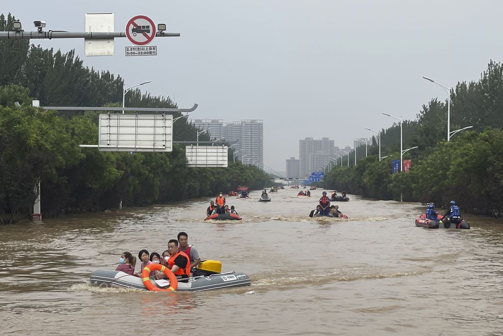 Warga dievakuasi dengan perahu karet melalui banjir di Zhuozhou di provinsi Hebei China utara, selatan Beijing, Rabu, 2 Agustus 2023. Ibu kota China itu mencatat curah hujan terberatnya setidaknya dalam 140 tahun selama beberapa hari terakhir. Di antara daerah yang paling terpukul adalah Zhuozhou, sebuah kota kecil yang berbatasan dengan barat daya Beijing. (AP Photo/Andy Wong)