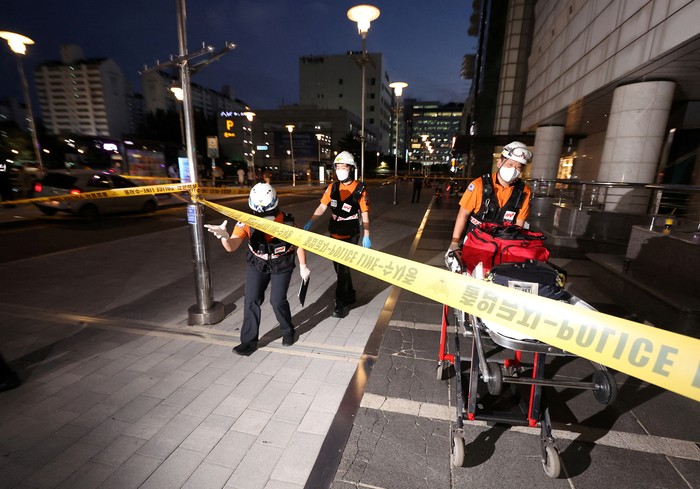 Policemen examine a scene where, according to media reports, nine people have been stabbed and four others hurt by a car driven by the suspected attacker in Seongnam, South Korea, August 3, 2023.   Yonhap via REUTERS   THIS IMAGE HAS BEEN SUPPLIED BY A THIRD PARTY. NO RESALES. NO ARCHIVES. SOUTH KOREA OUT. NO COMMERCIAL OR EDITORIAL SALES IN SOUTH KOREA.