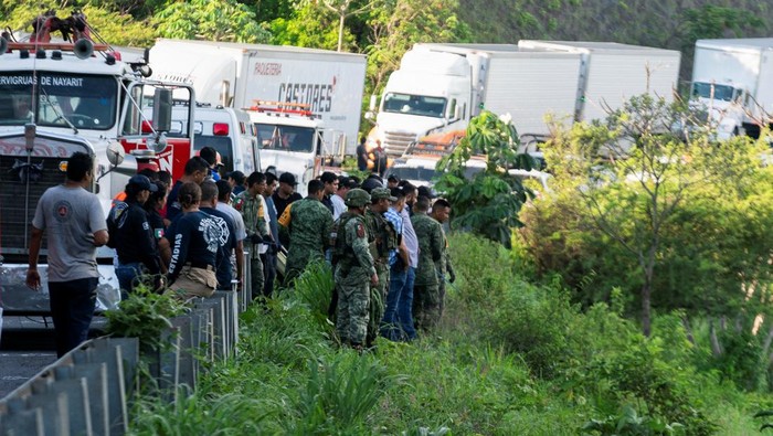 Authorities work to remove a passenger bus that plunged off a highway killing several people, in Tepic, Mexico August 3,2023. REUTERS/Christian Ruano
