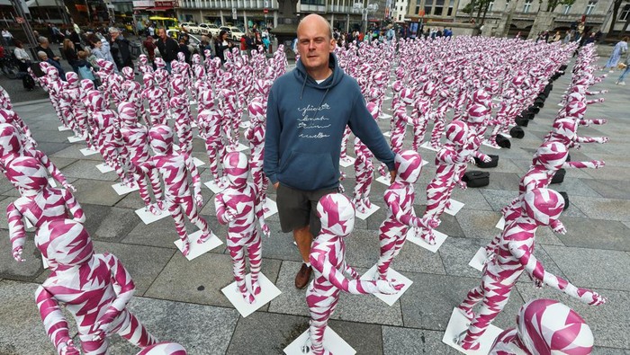 Instalasi Seni Jadi Bentuk Protes Skandal Pelecehan di Katedral Jerman A view of children mannequins wrapped in purple and white barricade tape placed in front of the Cologne Cathedral, installed there by German artist Dennis Josef Meseg, called
