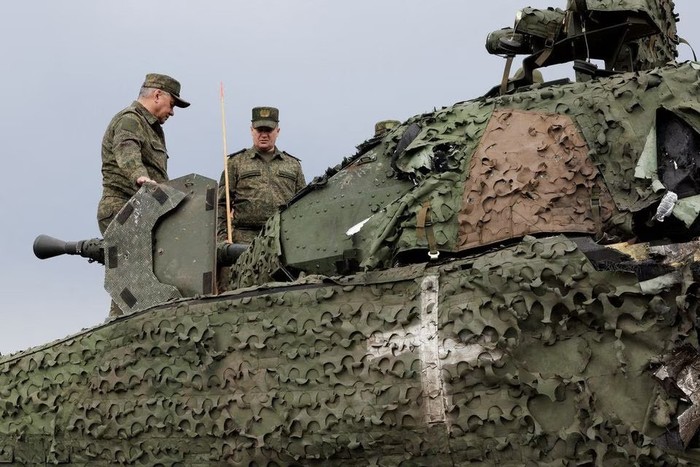 Russian Defence Minister Sergei Shoigu inspects a Swedish CV-90 infantry fighting vehicle, that was abandoned by Ukrainian soldiers after being hit by a hand-held anti-tank grenade, at the frontline headquarters of the Centre army group involved in Russia-Ukraine conflict, at an unknown location, in this picture released August 4, 2023. Russian Defence Ministry/Handout via REUTERS