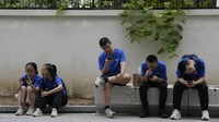 Youths look at their smartphones on the street in Beijing, Thursday, Aug. 3, 2023. Chinas internet watchdog has laid out regulations to curb the amount of time minors spend on their smartphones, in the latest blow to firms such as Tencent and ByteDance which run social media platforms and online games. (AP Photo/Ng Han Guan)