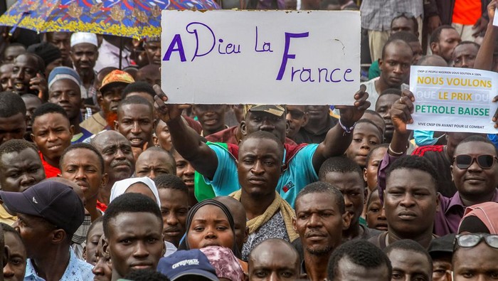 Thousands of anti-sanctions protestors gather in support of the putschist soldiers in the capital Niamey, Niger August 3, 2023. The sign reads 