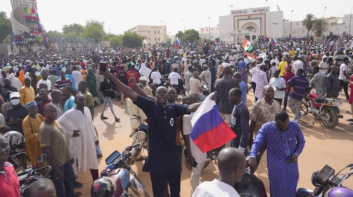 Nigeriens, some holding Russian flags, participate in a march called by supporters of coup leader Gen. Abdourahmane Tchiani in Niamey, Niger, Sunday, July 30, 2023. Not everyone is hostile to last week's coup in Niger. Neighboring Burkina Faso and Mali have taken the unusual step of declaring that foreign military intervention in Niger would be a declaration of war against them, too. Both have had coups in recent years. (AP Photo/Sam Mednick)