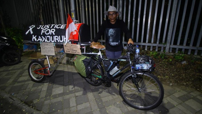 Suporter Arema Miftahuddin Ramly berpose dengan sepeda berhias keranda mayat di Stadion Gelora Bung Tomo, Surabaya, Jawa Timur, Jumat (4/8/2023). Aksi dengan mengusung tema Ekspedisi Lintas Stadion Jalur Pantura Malang-Jakarta hingga 17 Agustus 2023 tersebut untuk menggugah solidaritas dan kerukunan antarsuporter sepak bola di Indonesia sekaligus menuntut agar tragedi Kanjuruhan ditetapkan sebagai pelanggaran HAM berat. ANTARA FOTO/Moch Asim/rwa.