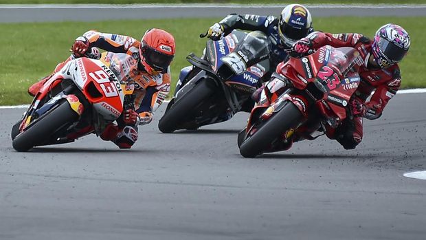Spain's rider Marc Marquez of the Repsol Honda Team, left, steers his motorcycle followed by Italian rider Enea Bastianini of the Ducati Lenovo Team, right, and Spain's rider Raul Fernandez of the CryptoDATA RNF Moto GP Team during the MotoGP race of the British Motorcycle Grand Prix at the Silverstone racetrack, in Silverstone, England, Sunday, Aug. 6, 2023. (AP Photo/Rui Vieira)