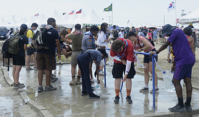 Attendees of the World Scout Jamboree rest in the shade at a scout camping site in Buan, South Korea, Friday, Aug. 4, 2023. More than 4,000 British Scouts will leave the World Scout Jamboree at a campsite in South Korea and move into hotels this weekend, the U.K. Scout Association said Friday, as concerns grow after more than 100 participants were treated for heat-related ailments. (Kim-yeol/Newsis via AP)