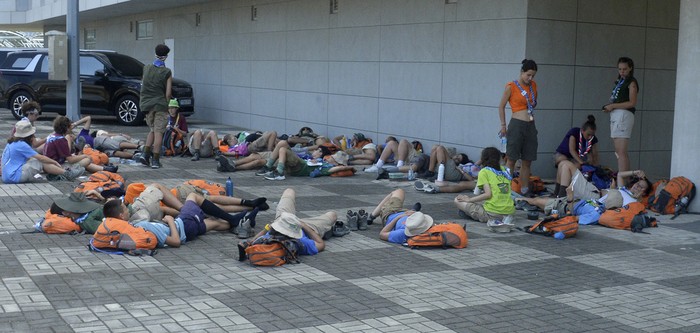Attendees of the World Scout Jamboree rest in the shade at a scout camping site in Buan, South Korea, Friday, Aug. 4, 2023. More than 4,000 British Scouts will leave the World Scout Jamboree at a campsite in South Korea and move into hotels this weekend, the U.K. Scout Association said Friday, as concerns grow after more than 100 participants were treated for heat-related ailments. (Kim-yeol/Newsis via AP)