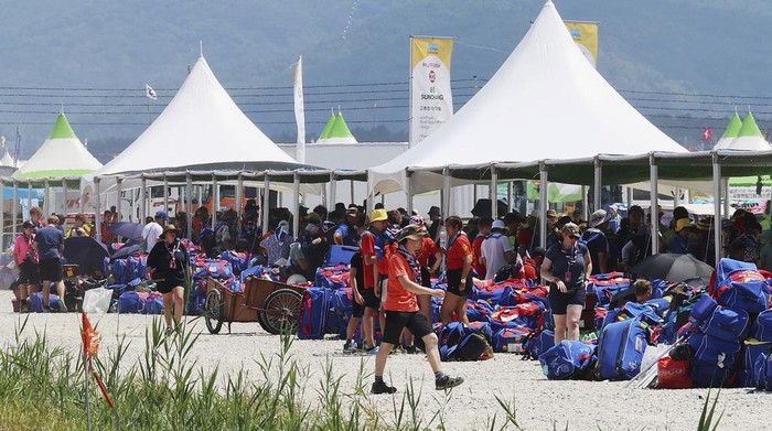 British scout members gather to leave the World Scout Jamboree campsite in Buan, South Korea, Saturday, Aug. 5, 2023. The world scouting body urged South Korea to cut short the World Scout Jamboree as thousands of British scouts began leaving the coastal campsite Saturday because of a punishing heat wave and American scouts talked of pulling out. (Kim Joo-hyung/Yonhap via AP)