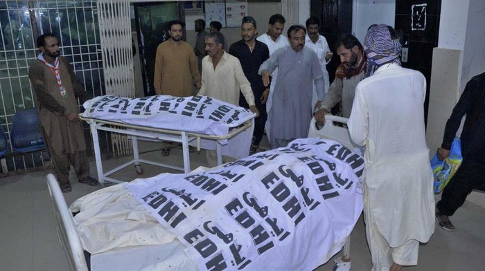 People receives bodies of their relative, who were died in a passenger train derailed incident, at a hospital, in Nawabshah, Pakistan, Sunday, Aug. 6, 2023. Railway officials say some passengers were killed and dozens more injured when a train derailed near the town of Nawabshah in southern Sindh province. (AP Photo/Pervez Masih)