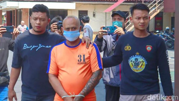 Pelaku pengancaman pemilik toko di Karawang saat digiring polisi di Mapolres Karawang