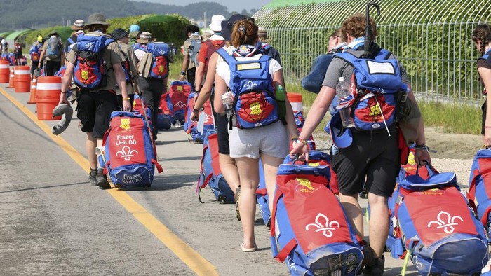 British scout members leave the World Scout Jamboree campsite in Buan, South Korea, Sunday, Aug. 6, 2023.  South Korea is preparing to evacuate tens of thousands of scouts from a coastal jamboree site as Tropical Storm Khanun looms, world scouting officials said Monday. (Choe Young-soo/Yonhap via AP)