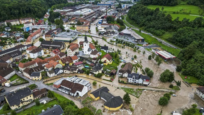 A flooded area is seen in Crna na Koroskem, Slovenia, Sunday, Aug. 6, 2023. The floods were caused by torrential rains on Friday which caused rivers to swell swiftly and burst into houses, fields and towns. Slovenia's weather service said a month's worth of rain fell in less than a day. Experts say extreme weather conditions are partly fueled by climate change. (AP Photo)