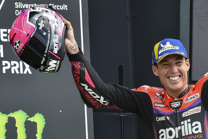 Spains rider Aleix Espargaro of the Aprilia Racing celebrates with trophy on the podium after winning the MotoGP race of the British Motorcycle Grand Prix at the Silverstone racetrack, in Silverstone, England, Sunday, Aug. 6, 2023. (AP Photo/Rui Vieira)