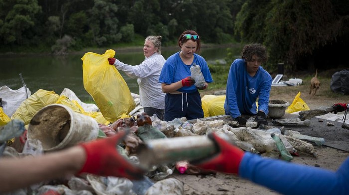 Aksi Relawan Bersihkan Sungai Hungaria dari Sampah Plastik Volunteers selectively sort the collected rubbish after they arrived to the campsite for that day on Tuesday, Aug. 1, 2023. The annual Plastic Cup competition has gathered around 330 tons of waste from the Tisza since 2013. Their aim is to preserve Hungary's natural environment, but also to head off a mounting global plastic waste crisis by cutting it off early in the cycle.Β (AP Photo/Denes Erdos)