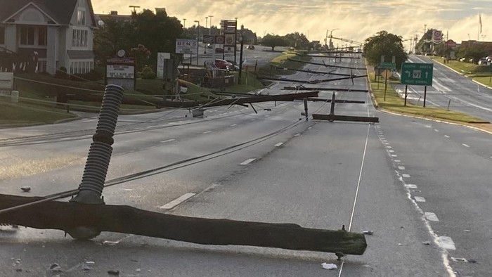 Fallen power poles lie along Route 140 in Westminster, Md., on Monday, Aug. 7, 2023. (Baltimore Sun Staff/The Baltimore Sun via AP)