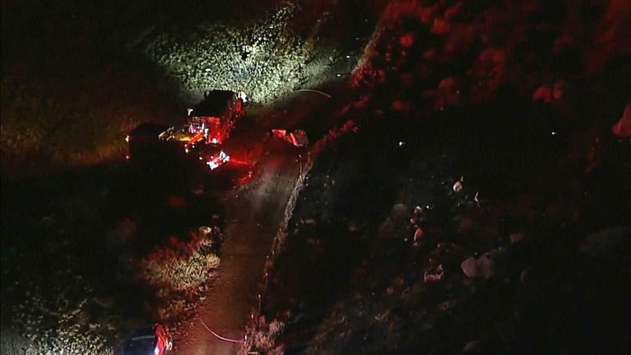 An investigation continues where two helicopters collided in Cabazon, Calif., on Monday, Aug. 7, 2023. Emergency officials say two firefighting helicopters collided while responding to a blaze in Southern California, sending one to the ground in a crash that killed all three people on board. The other helicopter landed safely after the collision Sunday. (Taya Gray/The Desert Sun via AP )