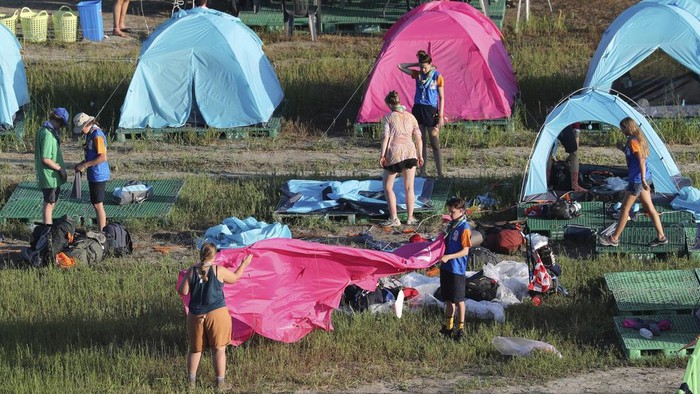 Attendees of the World Scout Jamboree prepare to leave a scout camping site in Buan, South Korea, Tuesday, Aug. 8, 2023. South Korea will evacuate tens of thousands of scouts by bus from a coastal jamboree site as Tropical Storm Khanun looms, officials said Monday. (Kim Myung-nyeon/Newsis via AP)