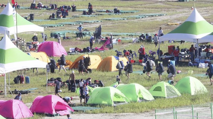 Attendees of the World Scout Jamboree prepare to leave a scout camping site in Buan, South Korea, Tuesday, Aug. 8, 2023. South Korea will evacuate tens of thousands of scouts by bus from a coastal jamboree site as Tropical Storm Khanun looms, officials said Monday. (Choe Young-soo/Yonhap via AP)