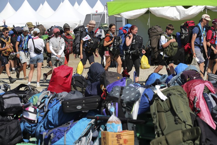 Attendees of the World Scout Jamboree leave a scout camping site in Buan, South Korea, Tuesday, Aug. 8, 2023. Buses began moving thousands of global Scouts from their campsite on South Koreas coast to inland venues Tuesday ahead of a tropical storm that is forecast to bring intense rains and strong winds to the peninsula within days. (Kim Myung-nyeon/Newsis via AP)